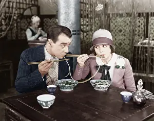 Foodstuff: Couple sharing a noodle in a restaurant