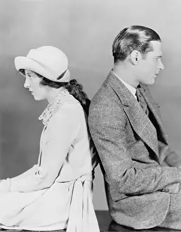 Tedium: Couple sitting back to back