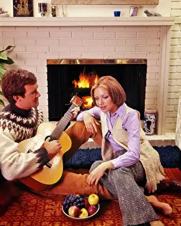 Entranced: Couple Sitting together by Brick Fireplace Man