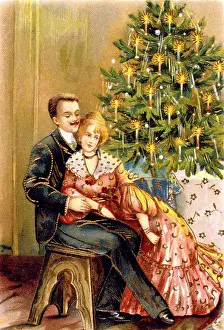 Couple sitting by a Christmas tree