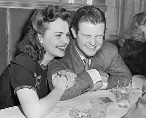Grimacing: Couple sitting together laughing and happy