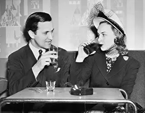 Flirtatious: Couple sitting together in a restaurant flirting