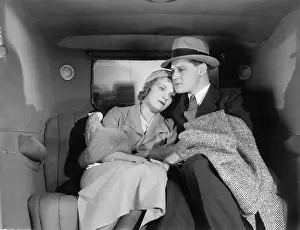 Woeful: Couple sitting together on the back seat of a car