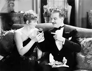 Sofas: Couple sitting together on a sofa and having a drink