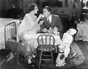 Miniatures: Couple sitting on a toy table having tea together