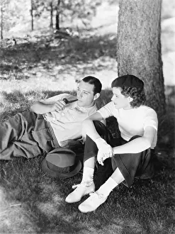 Closeness: Couple sitting under a tree