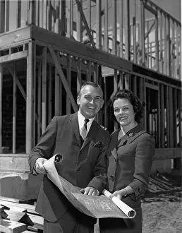 Blueprints: Couple standing in front of under construction house