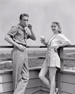 Romper: Couple Standing on Deck of Beach House