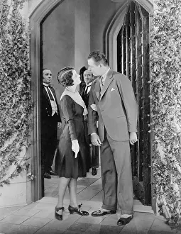 Argue: Couple standing in front of a door and having a fight