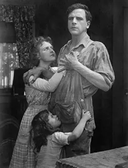 Remorse: Couple standing embraced with their daughter