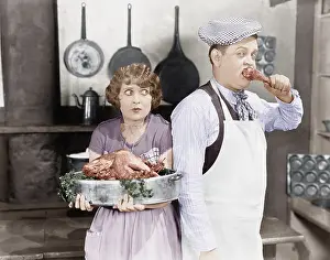Terrify: Couple standing together in a kitchen with a cooked turkey