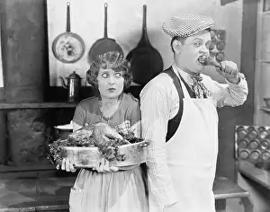 Terrify: Couple standing together in a kitchen with a cooked turkey