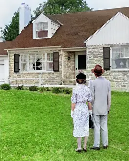 Domicile: Couple Standing Outside Looking at Stone Suburban