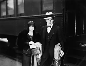Three Quarter: Couple standing at a railroad station platform