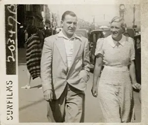 Greenhill: Couple strolling along the front on holiday in Weymouth