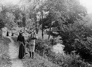 Strolling: Couple strolling by riverside, 1890s