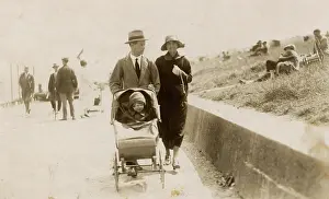 Grenville Collins / Tom Gillmor Collection: Couple strolling along the seafront with toddler in buggy