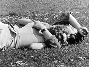 Sunbathe: Couple sunbathing on the grass