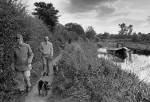 Walkies: Couple walking dogs by a canal