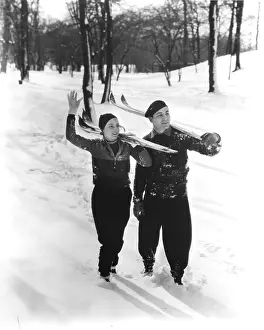 Skiis: Couple Walking In Snow Skiing