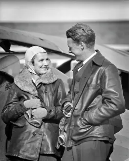 Copilot: Couple Wearing Leather Jackets Holding Goggles
