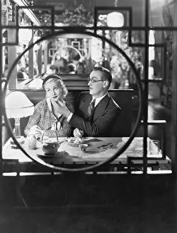 Irritated: Couple through window in restaurant