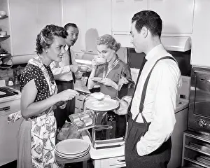 Deb001: Two Couples in Kitchen Having Coffee Serving Ham