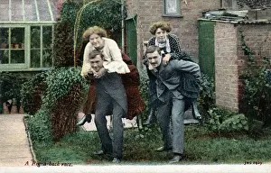 Two Couples have a piggy-back race in the back garden