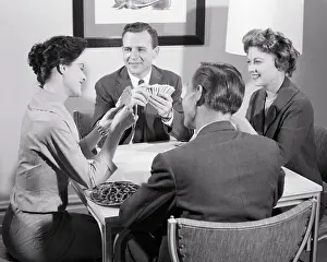 Pretzels: Two Couples Sitting at Table Playing a