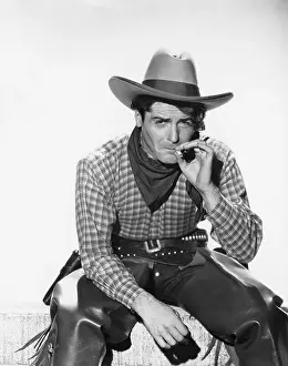 Attitudes: Cowboy with a cowboy hat smoking a cigarette