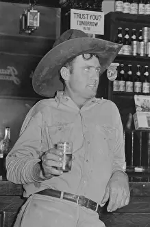 Parlor: Cowboy drinking beer in beer parlor, Alpine, Texas
