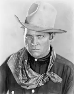 Scarfs: Cowboy with a hat looking sternly at the camera