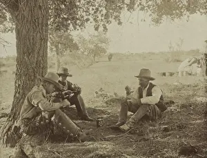 Broncos: Three cowboys sitting under a tree, having
