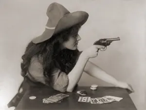 Revolvers: Cowgirl with deck of cards and chips, pointing ?