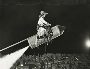 Mid Air: Cowgirl takes off on a rocket -