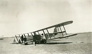Sepia Images: Crashed biplane with crew resting in the desert, Iraq