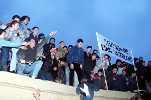 Glasnost: A crowd celebrates atop the Berlin Wall ?