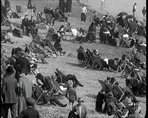 Deckchairs: A Crowd of Civilians Sitting On Deckchairs at the Beach
