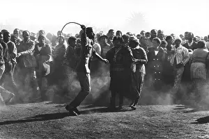 Spelled: Crowd control... a black policeman uses a sjambok