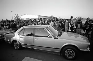 Earpiece: A crowd gathers on the pavement, peering into