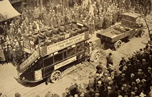 Towed: A crowd looks on as an early era London bus, is