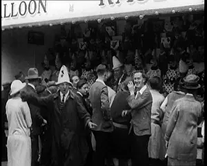 Encourages: A Crowd of People Standing In Front of a Carnival
