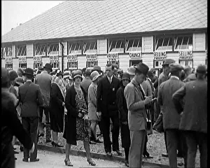 Placing: A Crowd of People Standing Outside A Totaliser/Tote