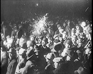 Spotlight: A Crowd of People Wave at a Spotlight Which