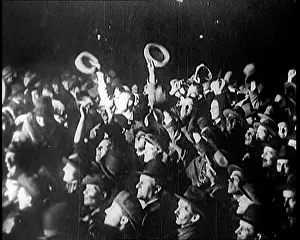 Spotlight: A Crowd of People Wave at a Spotlight Which