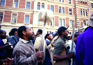 Assegais: A crowd of protesters, armed with cultural weapons