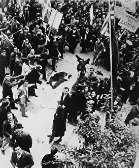 Rightist: Crowd shouting and pointing towards a dead man