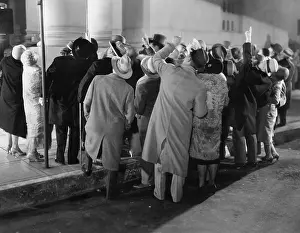 Fedora: Crowd in street looking up