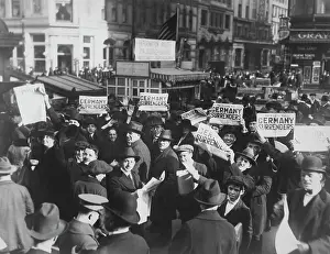 Armistice: Crowd at Times Square holding up Extras telling