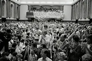 Predominantly: Crowded room of predominantly young, white people
